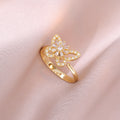 Bague papillon et fleur blanche dorée anti-stress ajustable