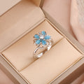 Bague fleur bleu pivotant argentée anti-stress ajustable